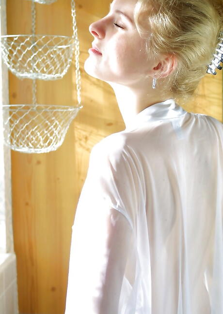 Slender blonde youthful Nelly baring big tits and spreading her legs 