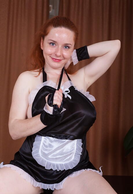 Charming redhead milf Sara Nikol shows big knockers and loves dildo 