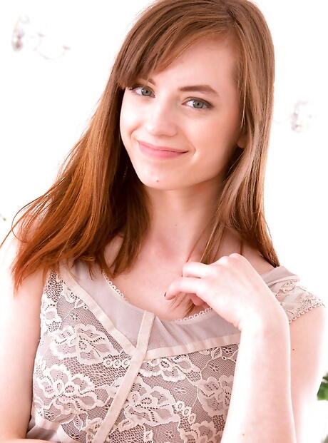 Luscious redheaded teen Paula exhibiting big knockers and hot ass 