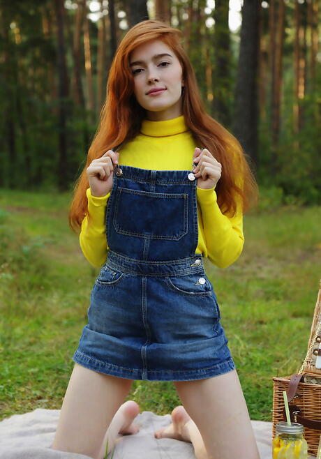 Sexy redheaded young Jia Lissa showing small tits and spreading her legs outside