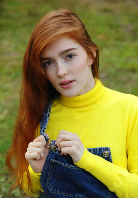 Sexy redheaded young Jia Lissa showing small tits and spreading her legs outside