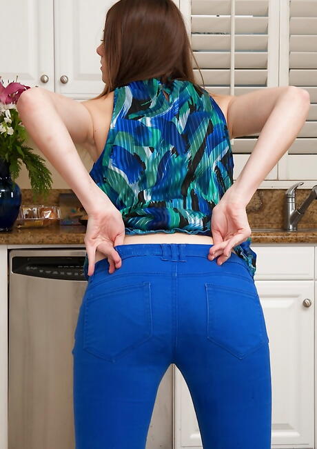 Slim american teen Shae Snow in jeans unveils small tits and bald pussy in kitchen