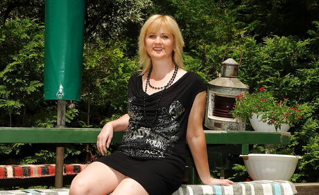 Curious blond mature Jennyfer in fancy skirt revealing her butt and spreading her legs outdoor