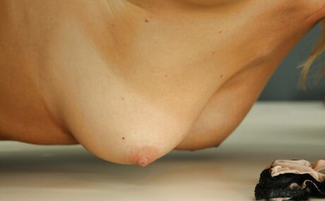 Enticing cutie Charlotta Phillip in stockings shows big titties and plays with dildo in office