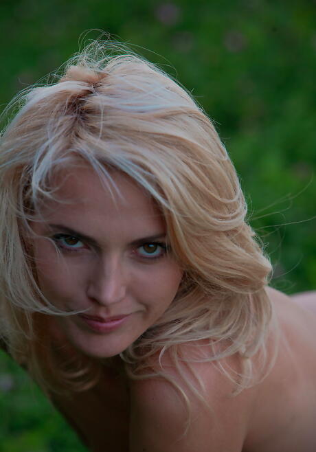 Shapely blond teen Lilly A uncovers tiny tits and hairy pussy outdoor