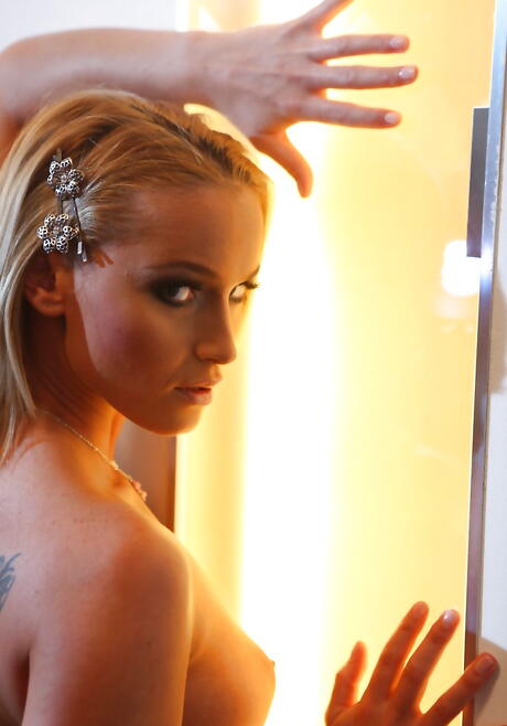 Peachy blond milf Caty Campbel bares big hooters and sexy ass 