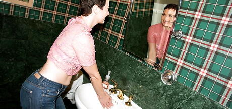 Curious american aged Kali Karinena bares small tits and masturbates in bathroom