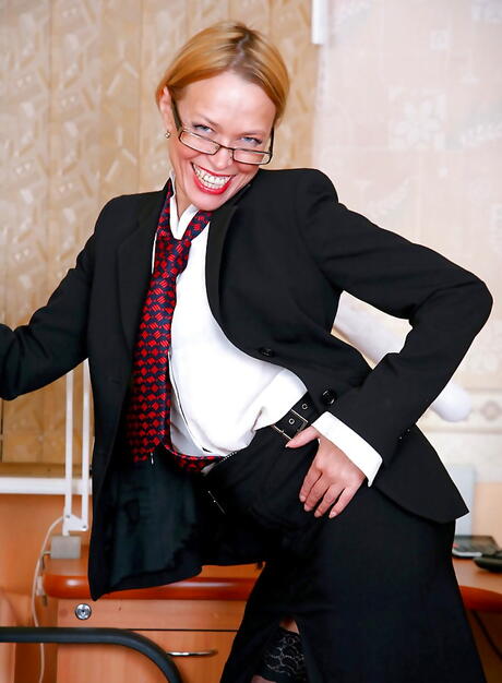 Sexy blonde mature Olga in fancy skirt shows her butt and jerks off in office