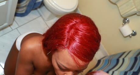 Sultry ebony redhead amateur Danielle Reid work with wet lips on cock and enjoys a cum shot in her mouth in the bathroom