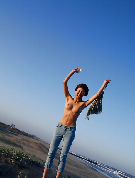 Hot japanese teen Yu Satome in jeans shows big hooters and sexy butt at beach