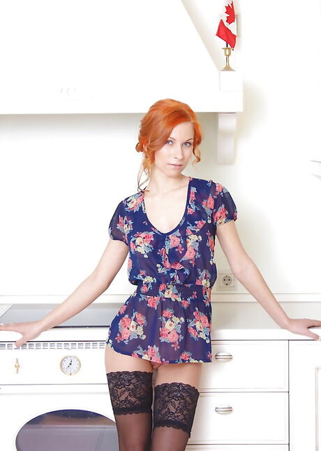 Hot czech redhead Daisy Lee in skirt baring her ass and bald pussy in the kitchen