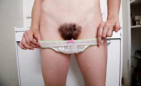 Sylphlike american teen Kasey Warner in shorts exposes tiny tits and spreads her legs in the kitchen