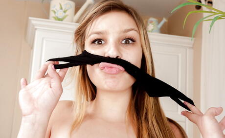 Foxy latin young Carmen Caliente exposes her butt in sexy panties and spreads her legs 