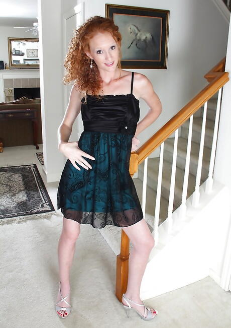 Sultry redheaded mature Ande exposes tiny tits and pussy 