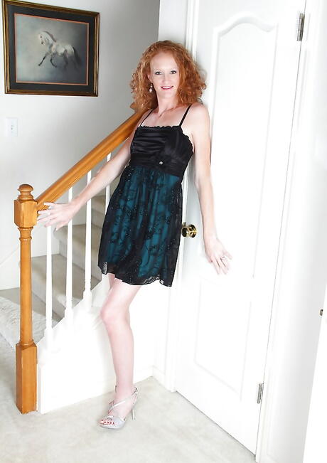 Sultry redheaded mature Ande exposes tiny tits and pussy 