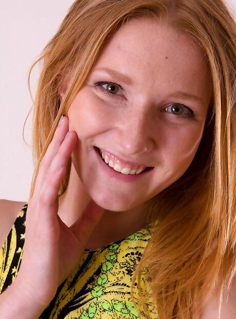 Very attractive red-haired milf Bambi exposes big knockers and pussy 