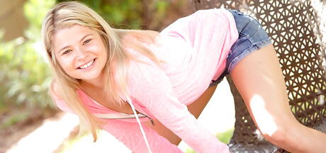 Foxy american blond young Mindy in shorts revealing her butt outside