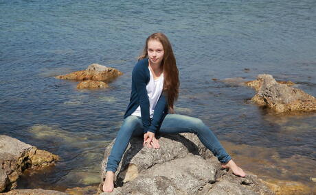 Gracile blonde teen Milena D in jeans exhibits small tits and butt on the beach