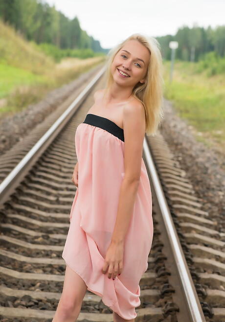 Sylphlike blonde teen Bernie shows small tits and spreads her legs outdoor