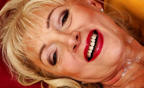 Very attractive blond mature Janet Lesley sucking on huge cock and gets a cum blast on face 