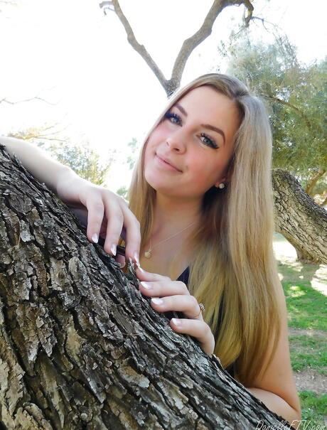 Tempting blond babe Danielle Delaunay in sexy skirt showing big boobies and loving sex toy outside