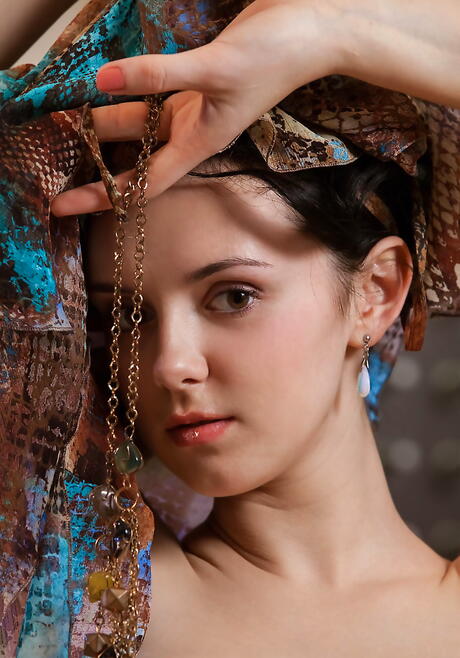 Hot dark-haired teen Anatali in fancy skirt exhibits big knockers and shaved pussy in kitchen