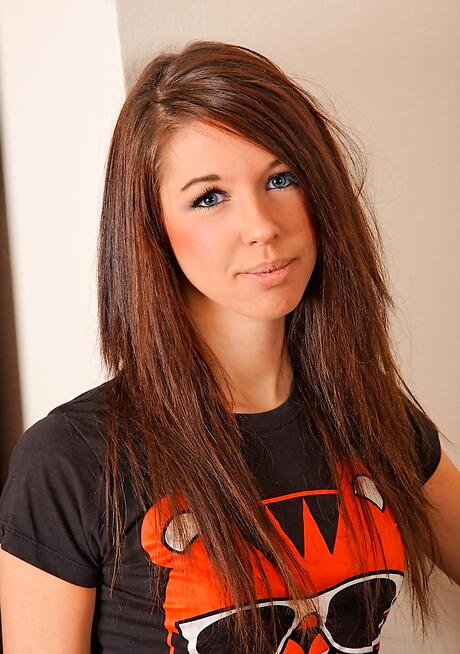 Slim young Rosie in tight jeans exhibits her butt and spreads her legs 