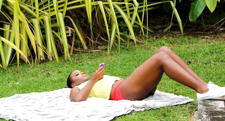 Sultry black amateur Eva Quinn exposing big hooters and sexy butt outdoor