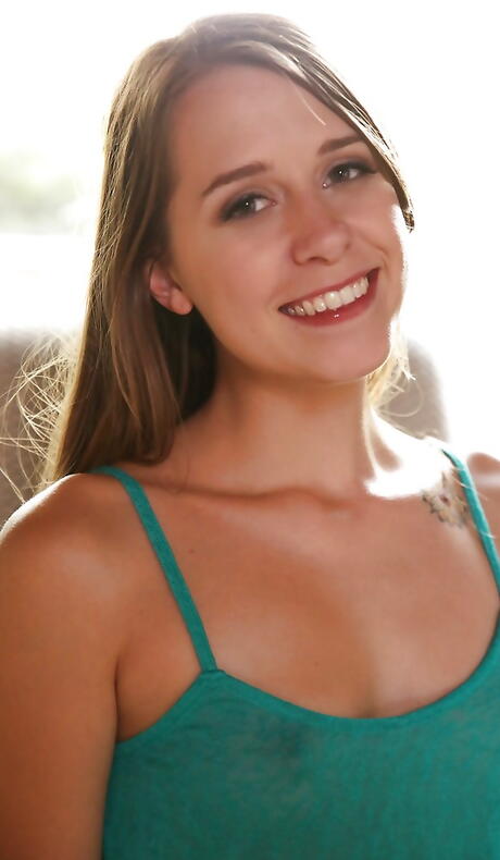 Sexy american youthful Zoey Laine in fancy shorts exposing small tits and playing with sex toy 