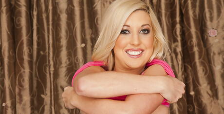 Hot blond porn star Callie Cobra in sexy skirt denudes small tits and cute pussy 