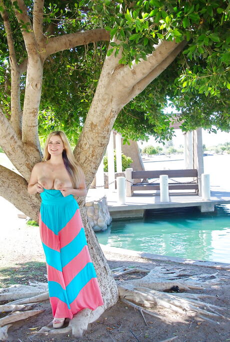 Glamorous blond cutie Danielle Delaunay exhibiting big titties and playing with dildo outside