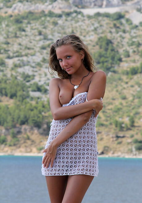 Hot blond youthful Katya Clover in fancy skirt uncovering tiny tits and shaved pussy at beach