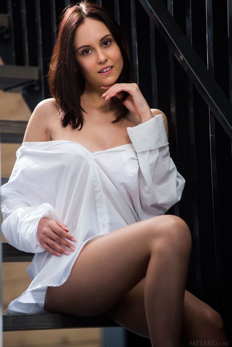 Sexy brunette Sade Mare removes her clothes and poses naked on a fire escape