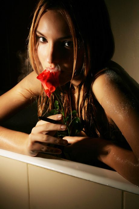 Skinny blonde Kira W gets naked in a bathtub while smoking a cigarette