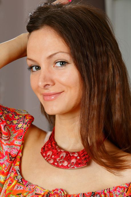 Alluring teen Zhanet A removes her dress to model in the nude