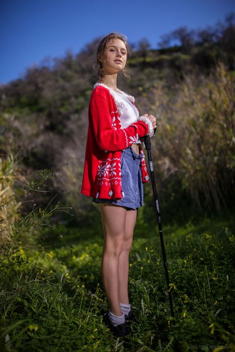Slim teen Clarice A models totally naked in a field of wildflowers