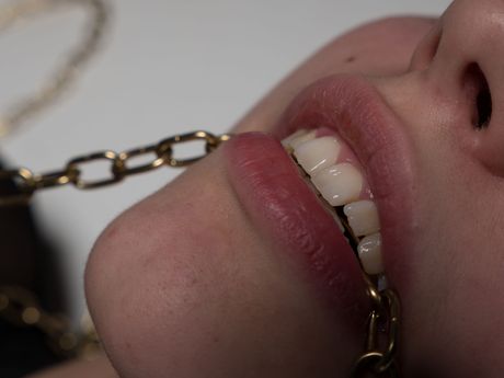 Blonde teen Lizzy B removes her lingerie and stockings before masturbating