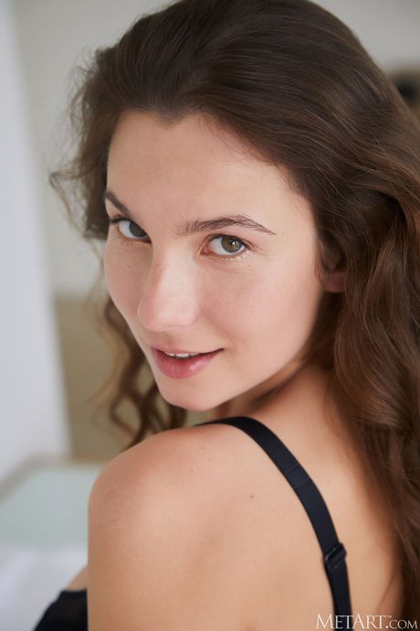 Cute teen Belka removes her lingerie to get totally naked on her bed