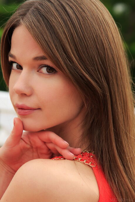 Cute teen Nedda A strips naked in the garden & shows her hairy pussy