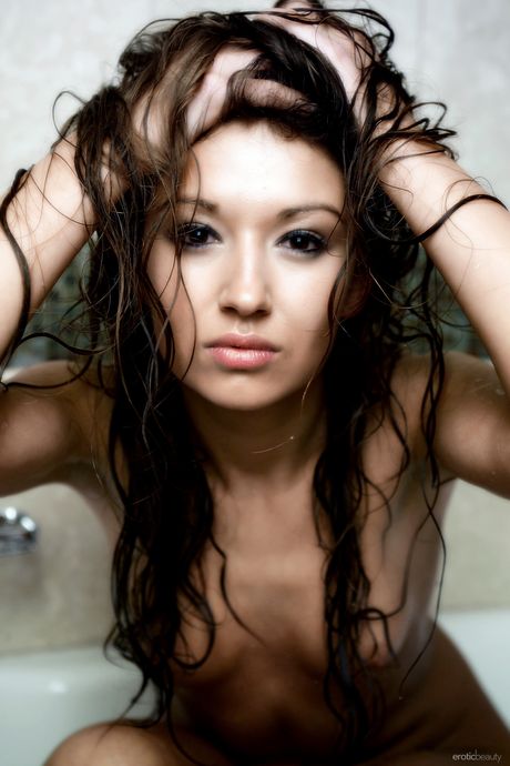 Endearing teen Adrienne gets naked in a shower while wearing boots