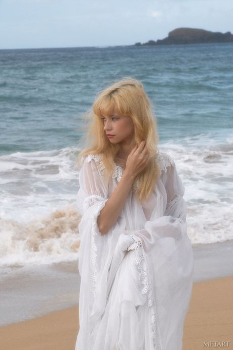 Blonde teen Jane A shows her small tits and poses naked on the beach