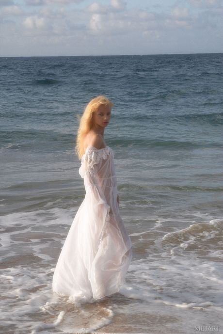 Blonde teen Jane A shows her small tits and poses naked on the beach