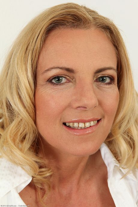 Mature secretary Britney strips and touches her pussy at the office