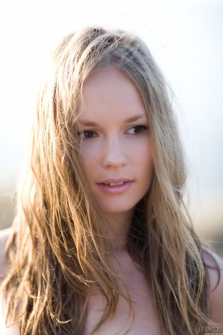 Desirable teen Caesaria A shows her tiny tits and bald pussy in the backyard