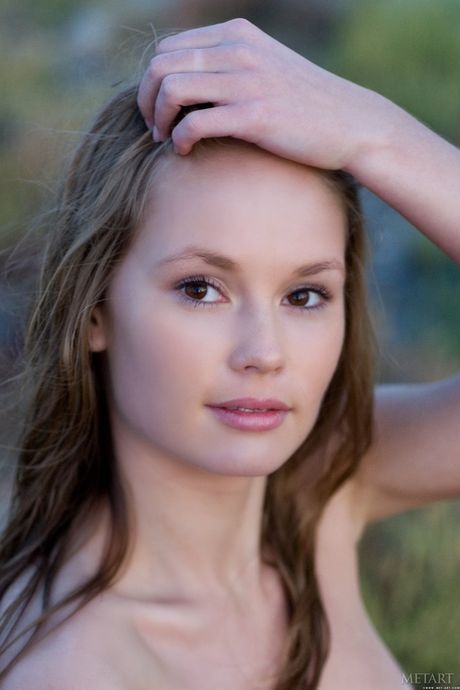 Desirable teen Caesaria A shows her tiny tits and bald pussy in the backyard