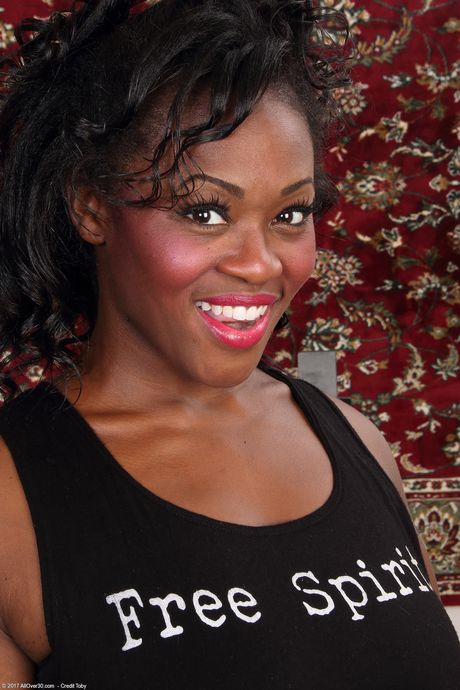 Sexy ebony MILF Sunny strips and shows her big ass and shaved pussy