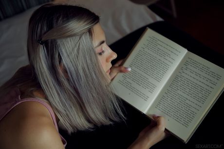 Cute teen Eva Elfie fingers her pussy after reading a book on her bed