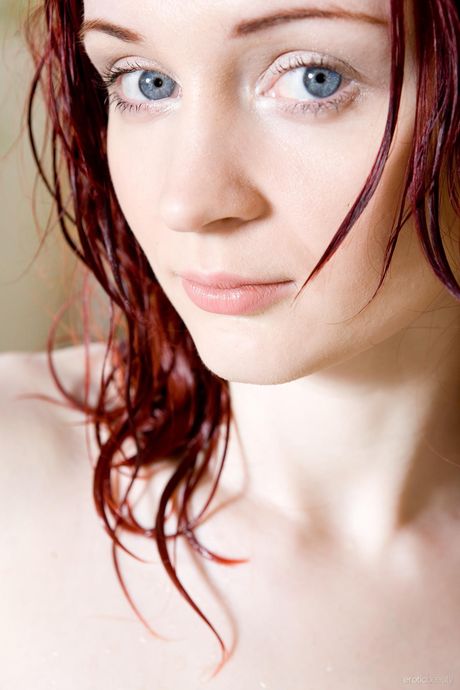 Sexy redhead Mylene poses naked in the kitchen to show off her hot body