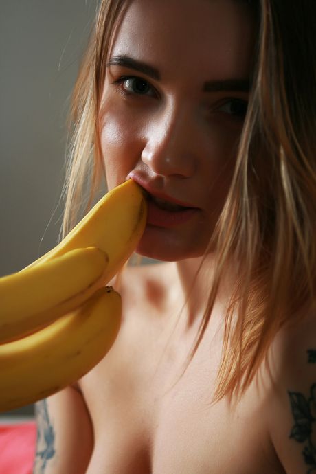 Delightful teen Roksya gets naked in the kitchen while eating fruit