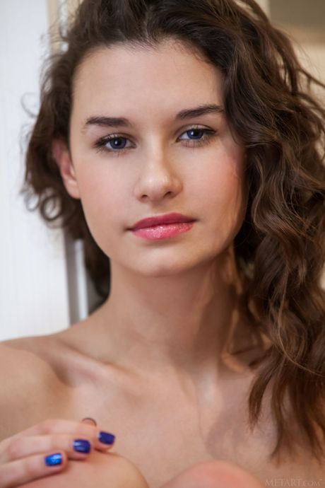 Delicate teen Cristin removes her lingerie and panties to pose nude